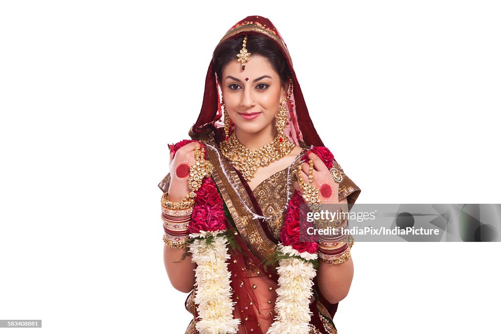 Beautiful bride holding a garland