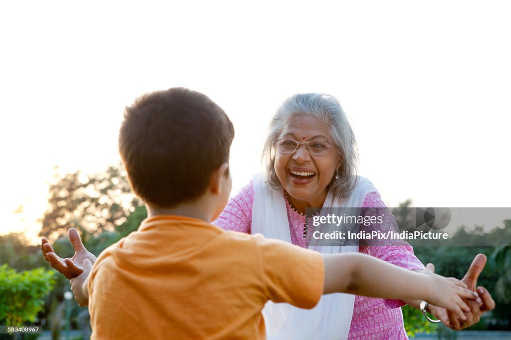 Grandmother about to hug grandson