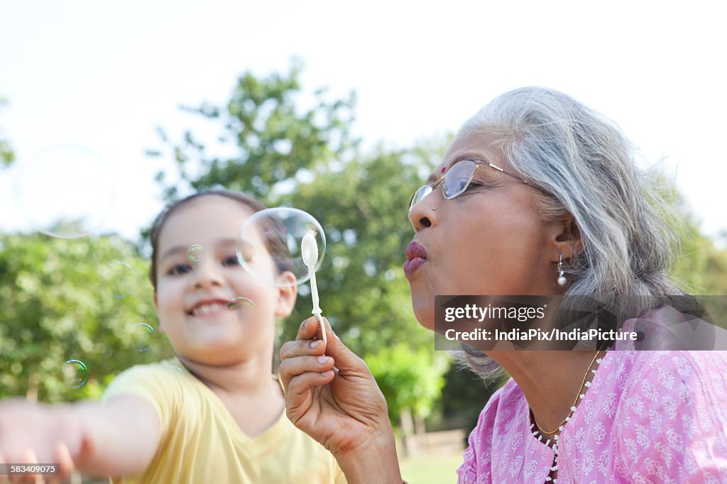 Senior woman blowing bubbles