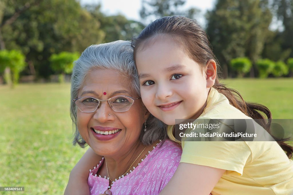 Portrait of grandmother and granddaughter smiling