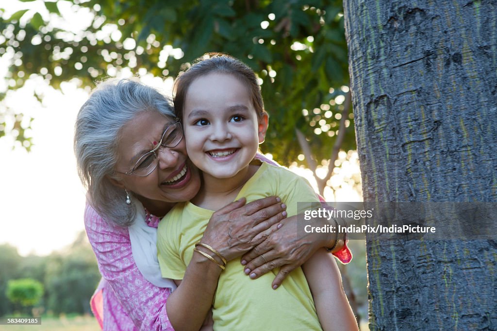 Grandmother hugging granddaughter