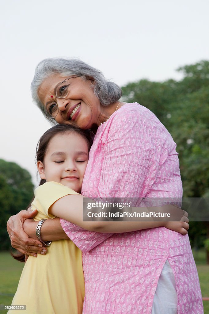 Grandmother and granddaughter hugging