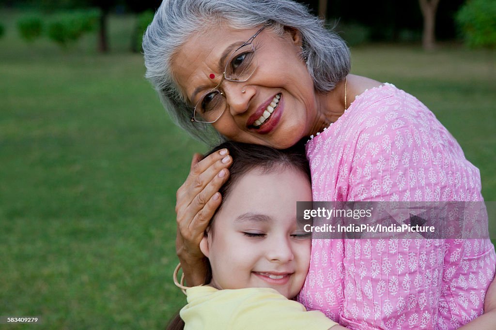 Grandmother and granddaughter hugging