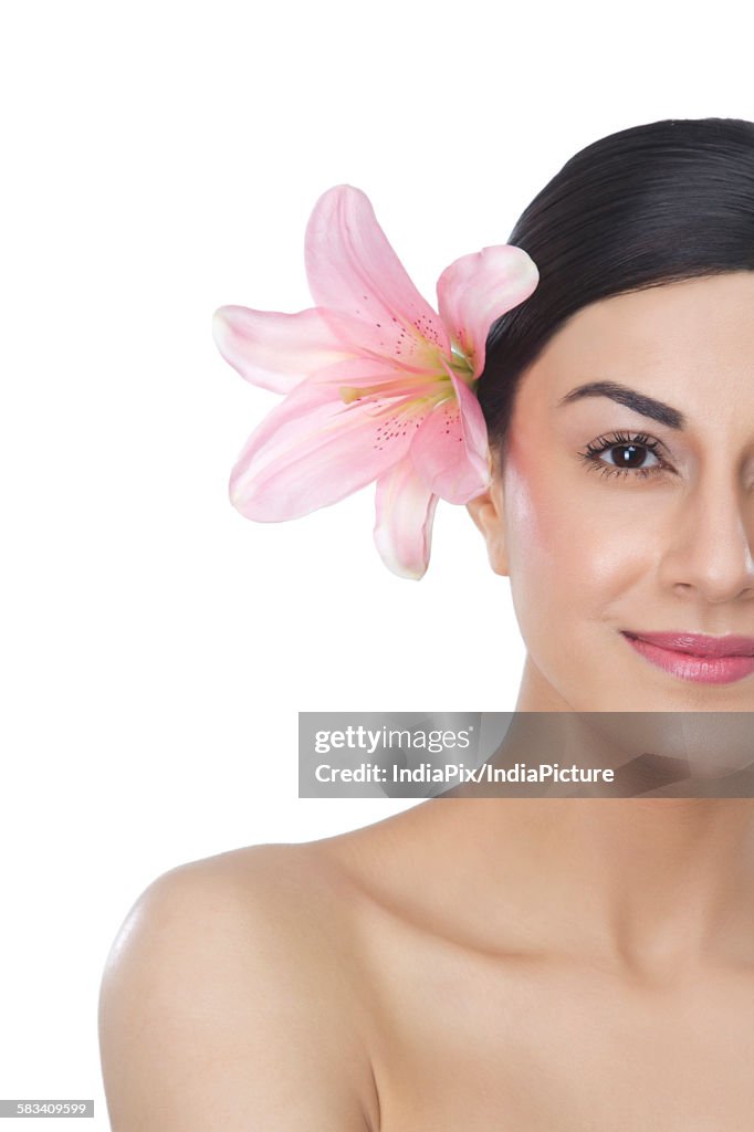 Portrait of a beautiful woman with flower in hair