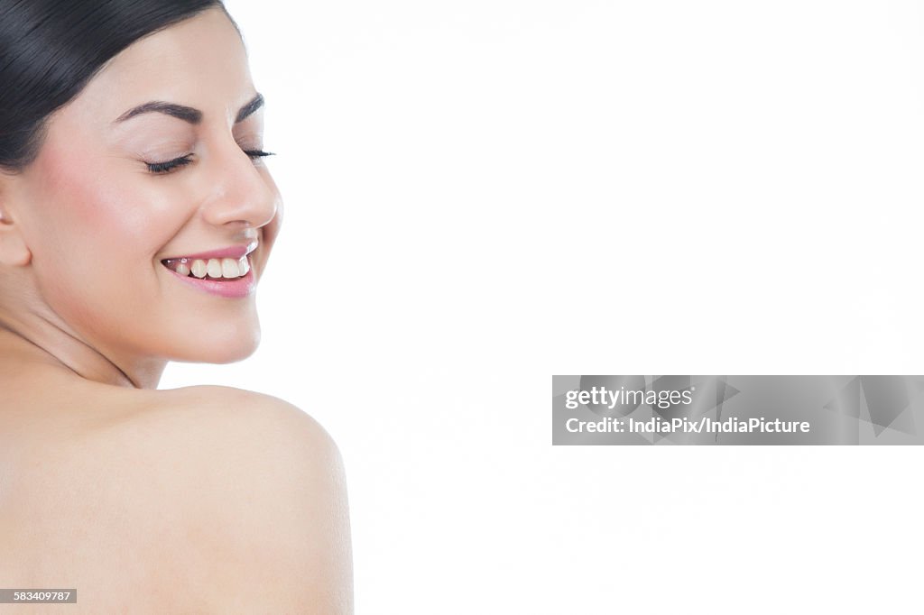 Beautiful woman with eyes closed smiling