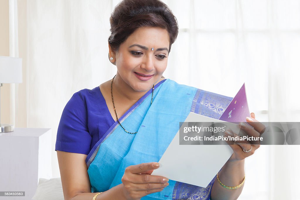 Senior woman reading a greeting card