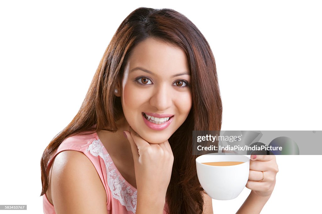 Portrait of a young woman with coffee