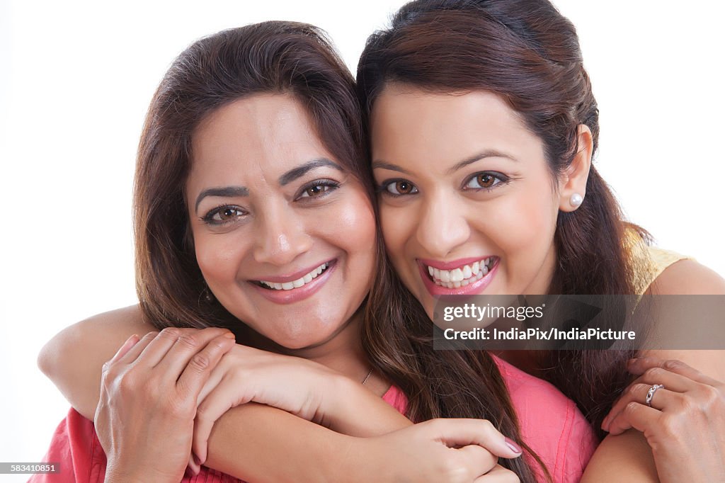 Portrait of mother and daughter smiling