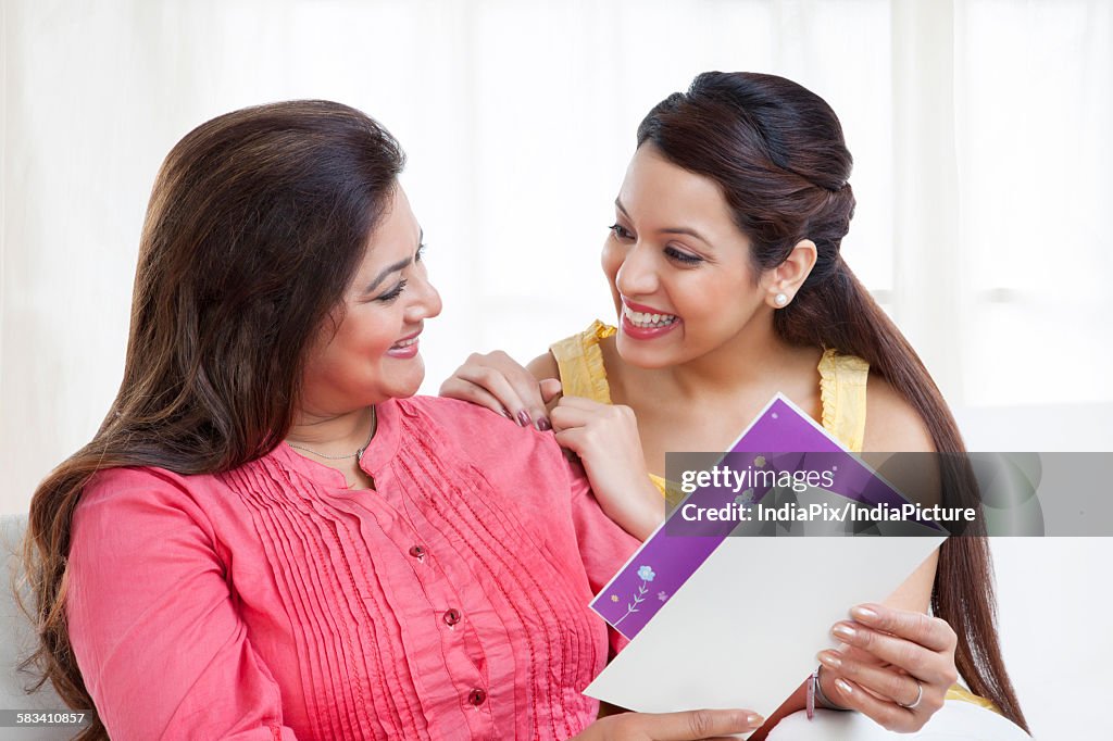 Mother and daughter with greeting card