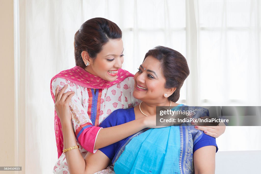 Mother and daughter smiling