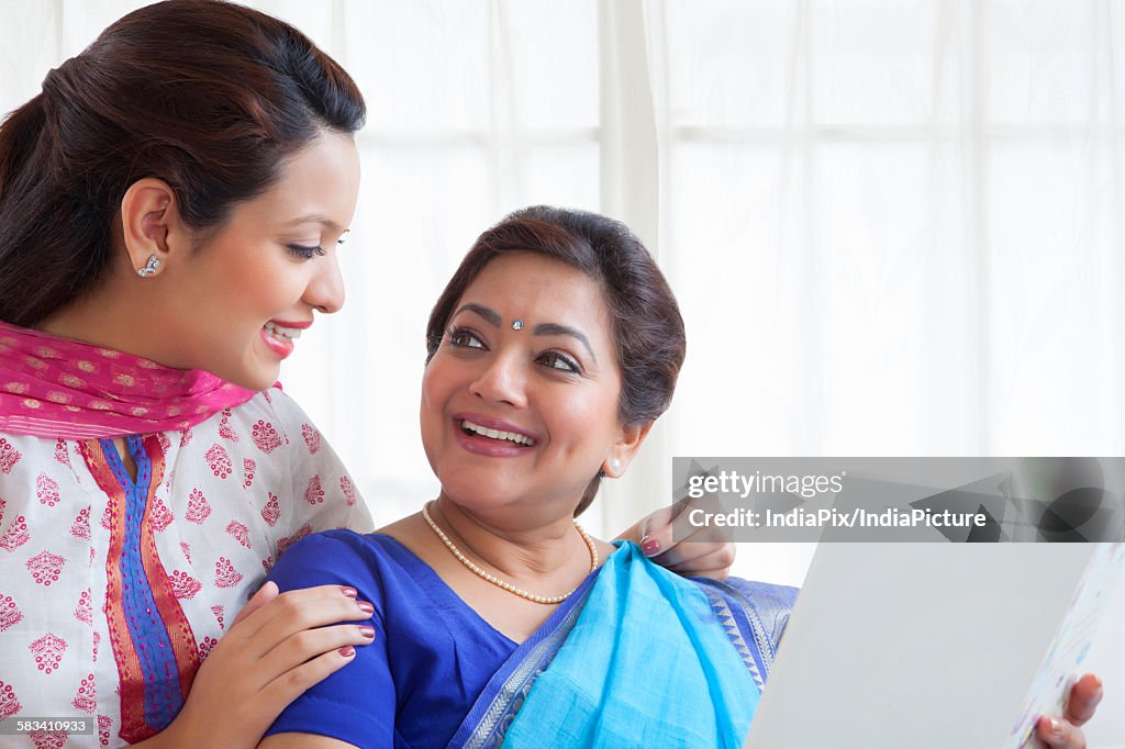 Mother and daughter with a card