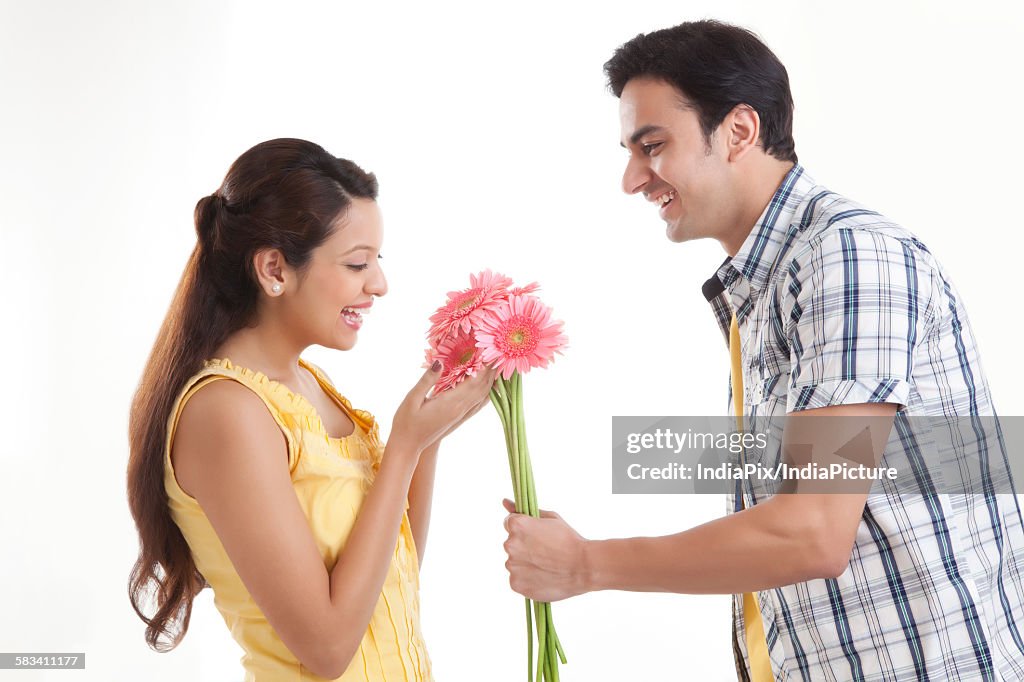Man giving flowers to woman