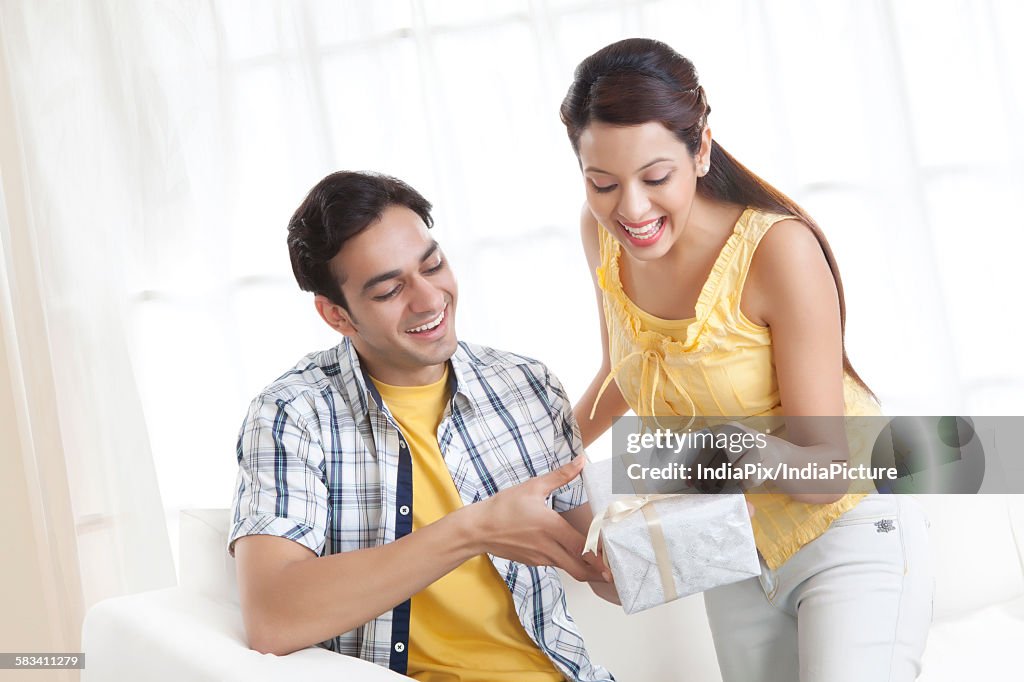 Young couple with a gift box