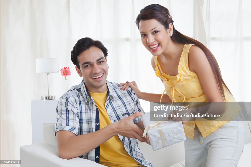 Portrait of a young couple with a gift box