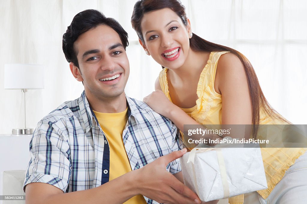 Portrait of a young couple with a gift box