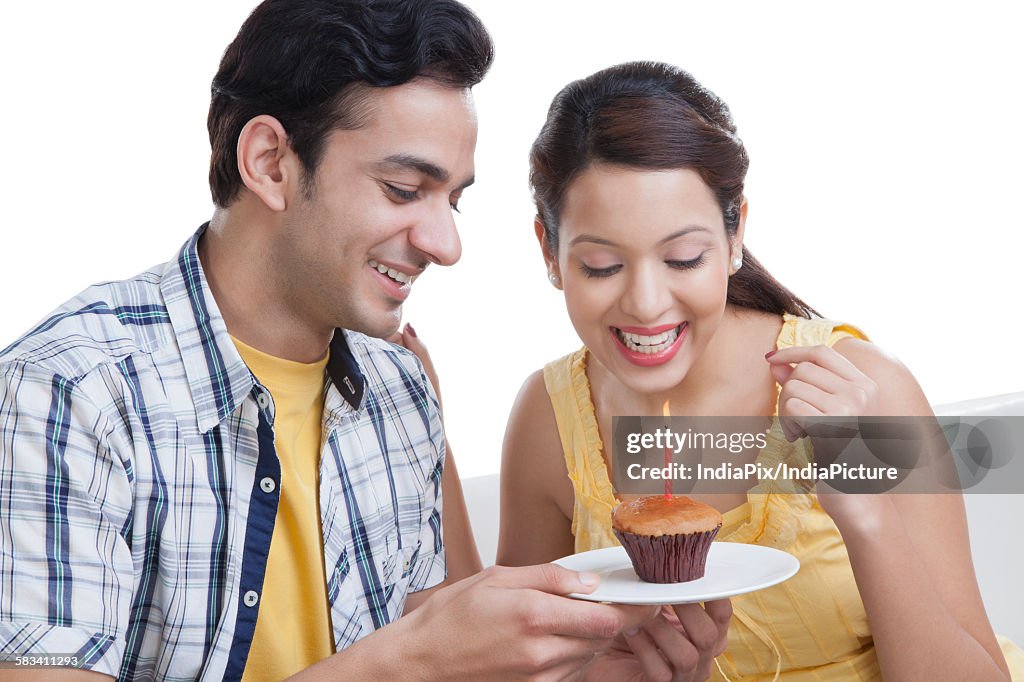 Young couple looking at a cupcake