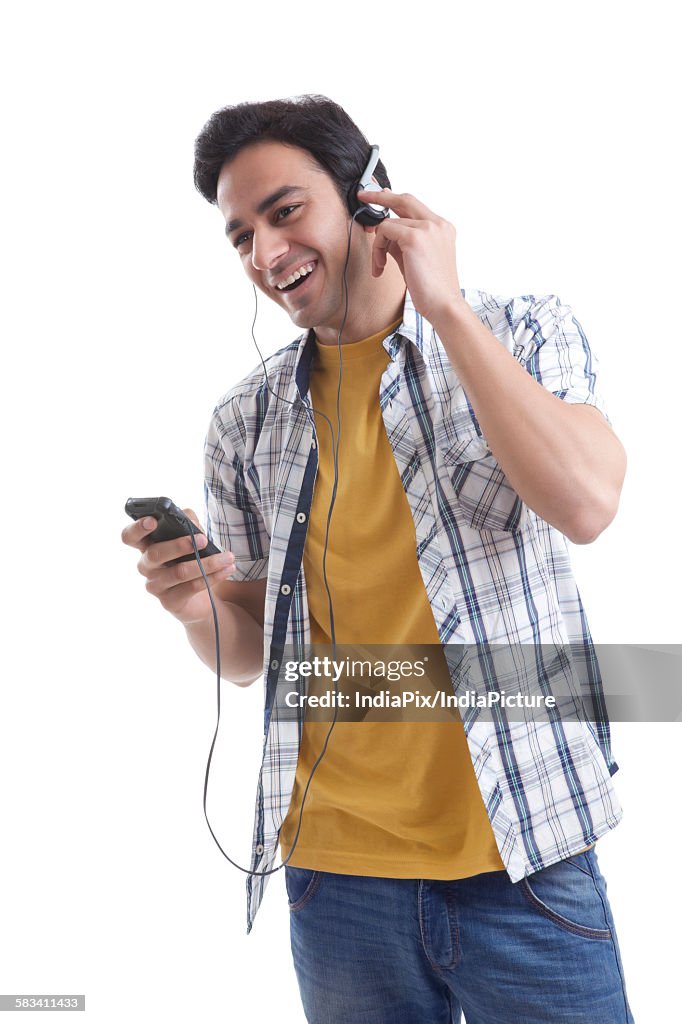 Young man listening to music on mobile phone