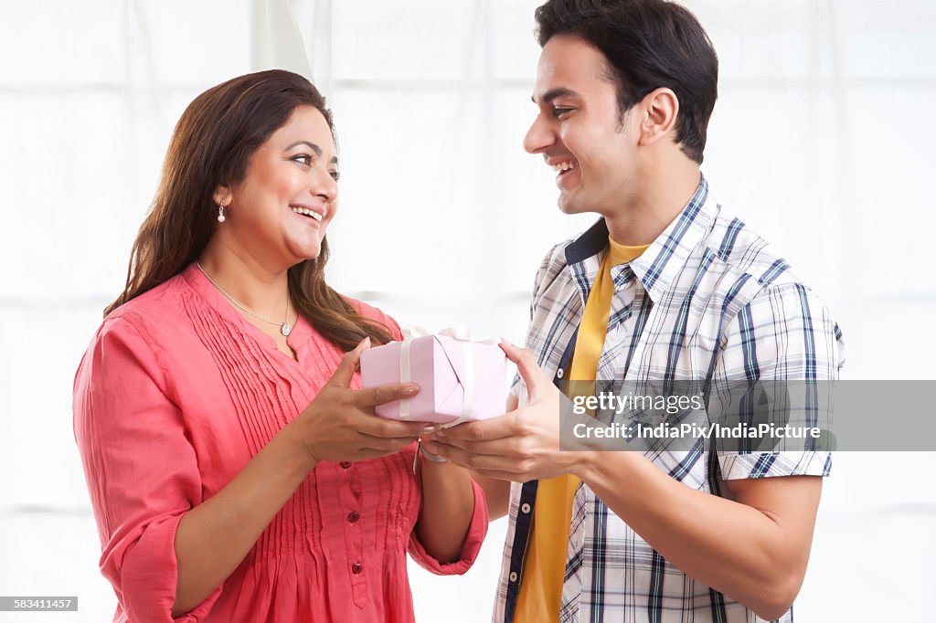 Son giving his mother a gift