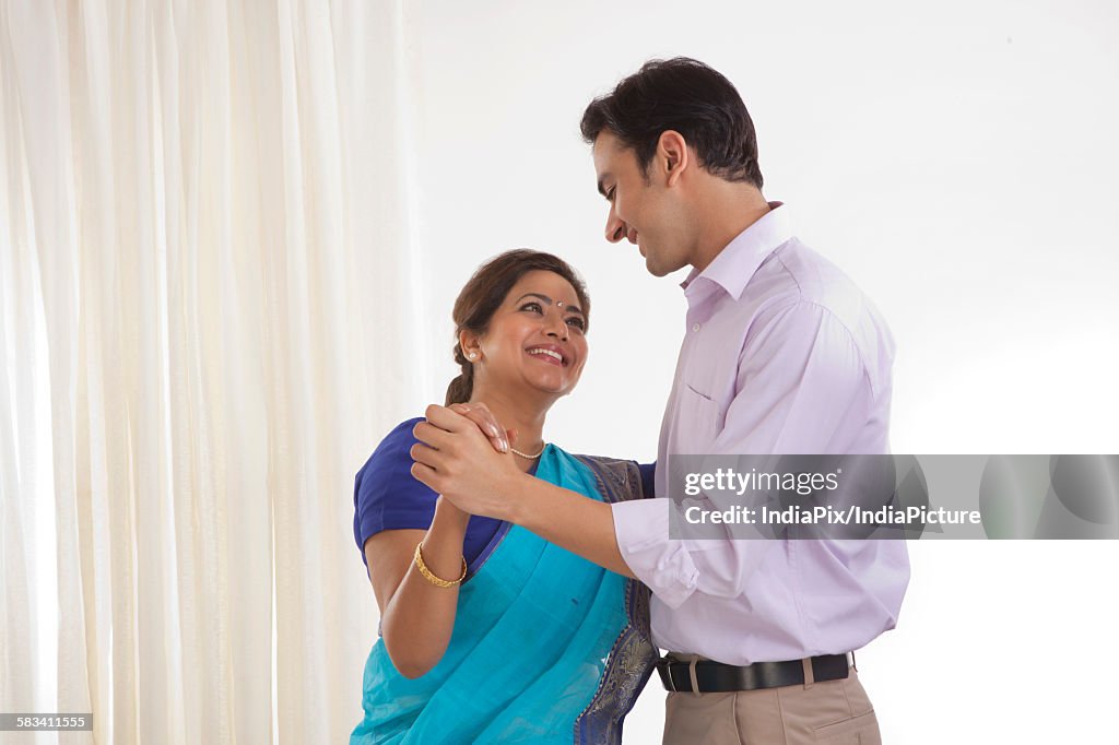 Mother and son dancing together