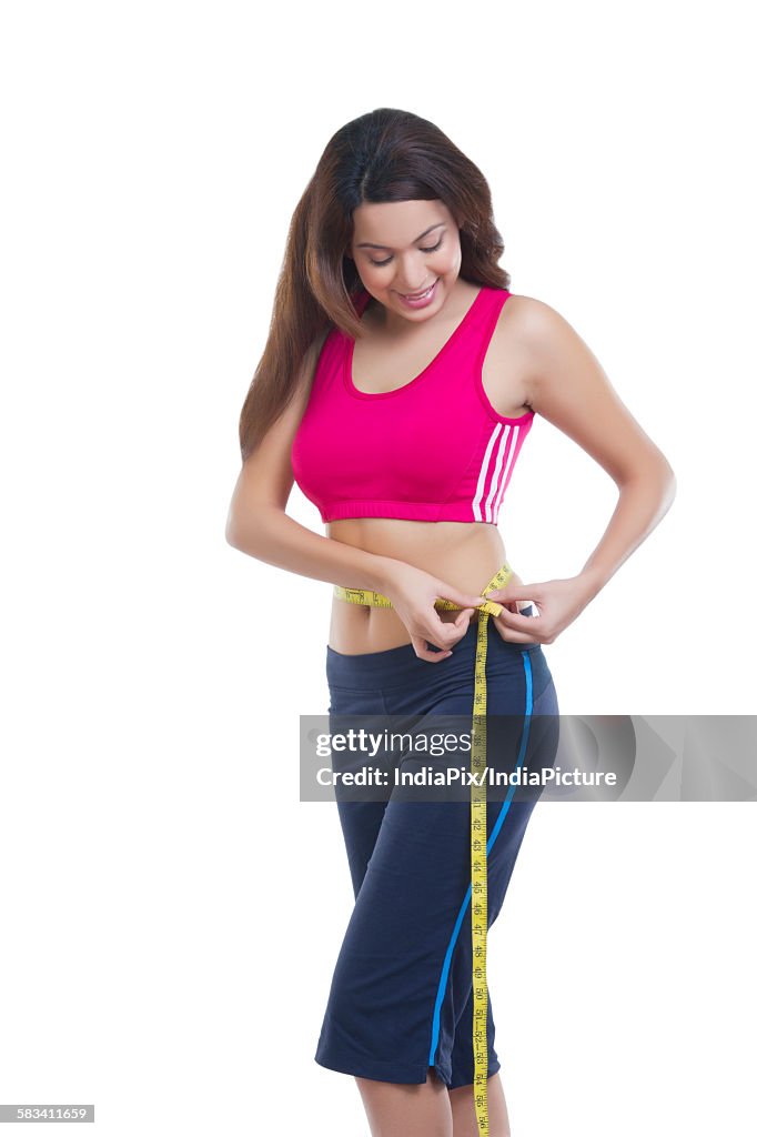 Woman measuring her waist