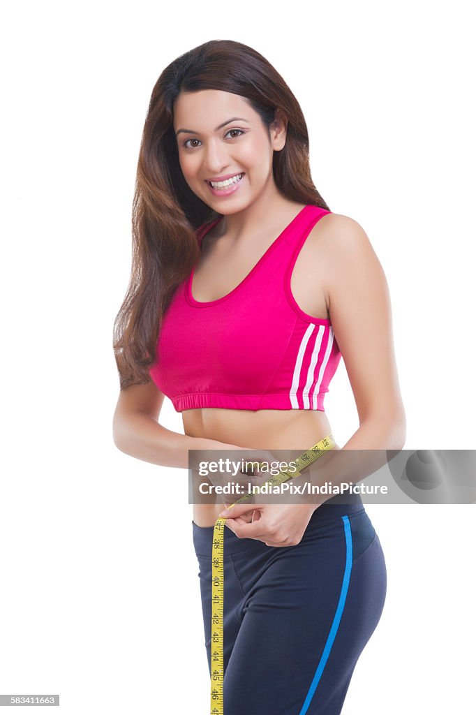 Woman measuring her waist