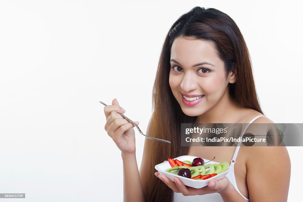 Portrait of woman with a bowl of fruits