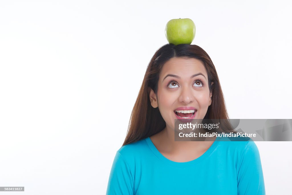 Woman balancing apple on head