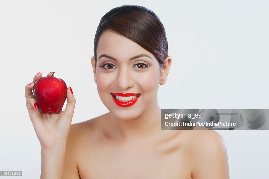 Portrait of a woman holding an apple