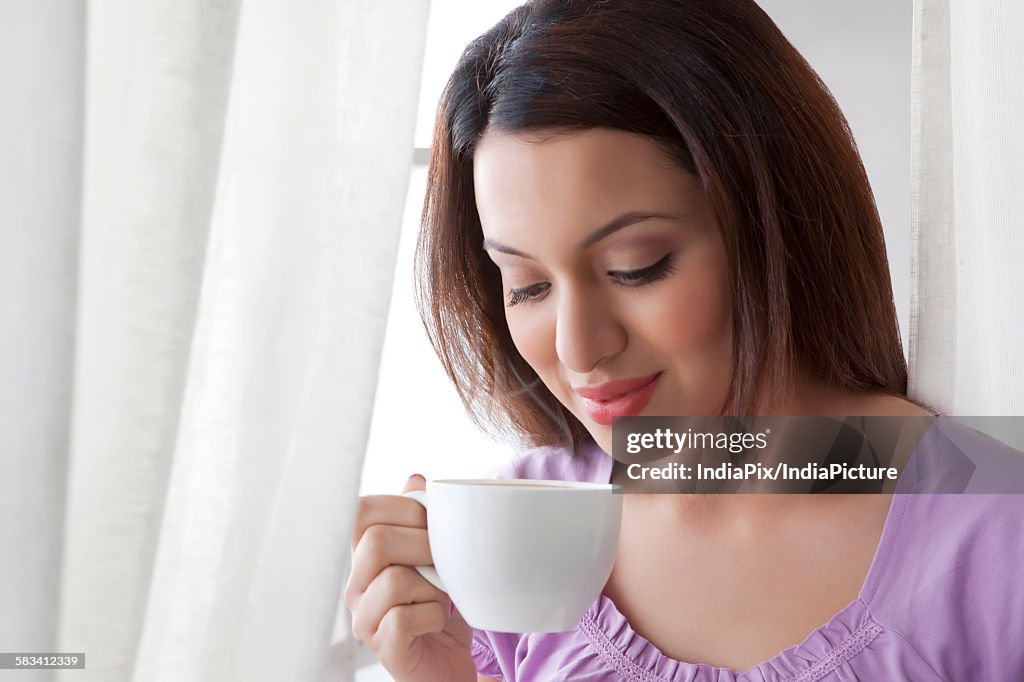 Young woman drinking a cup of coffee