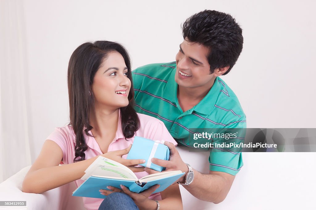 Man giving a gift to his woman friend