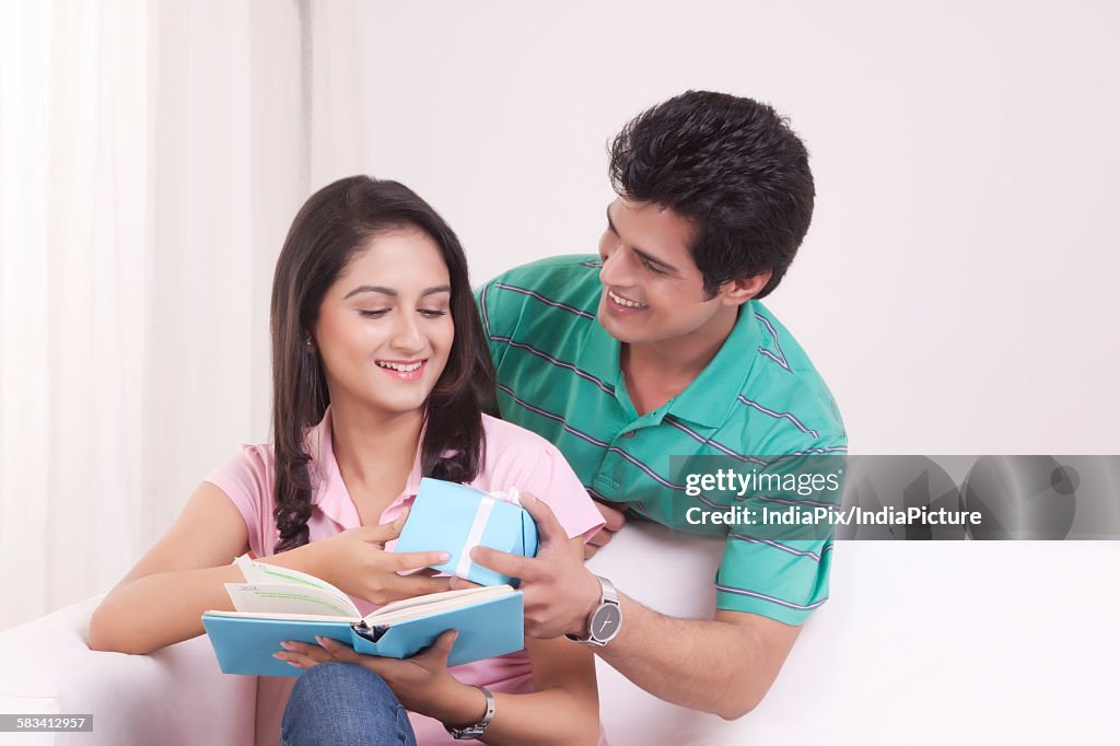 Man giving a gift to his woman friend