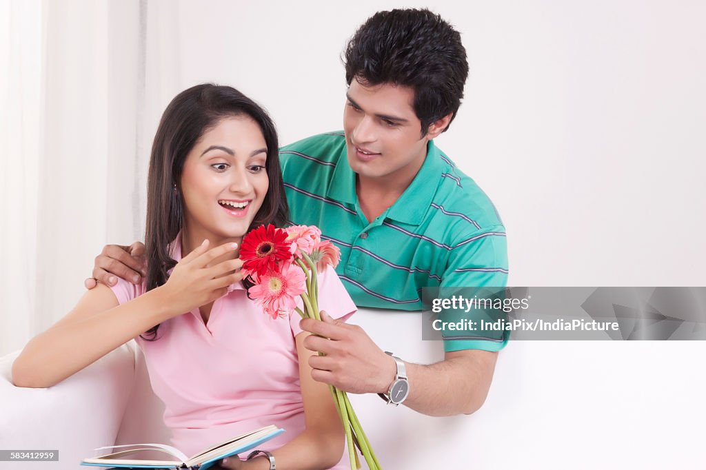 Man giving flowers to his girl friend