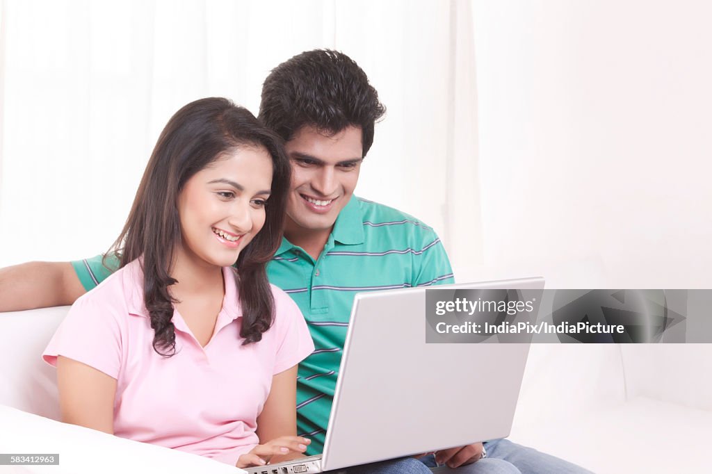 Young man and woman working on the laptop