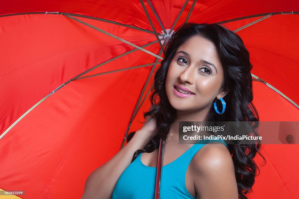 Young woman with red umbrella