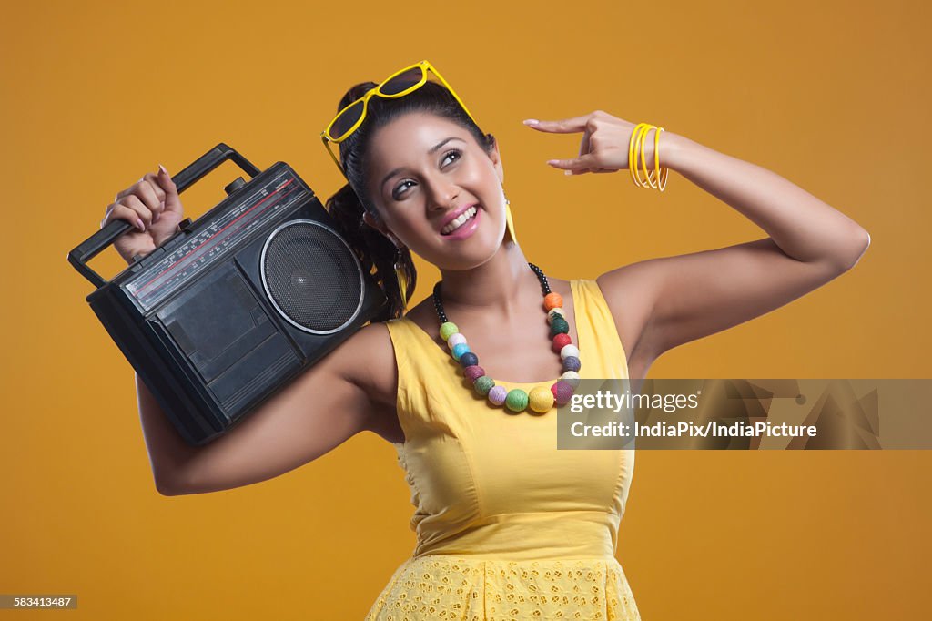 Young woman with cassette player