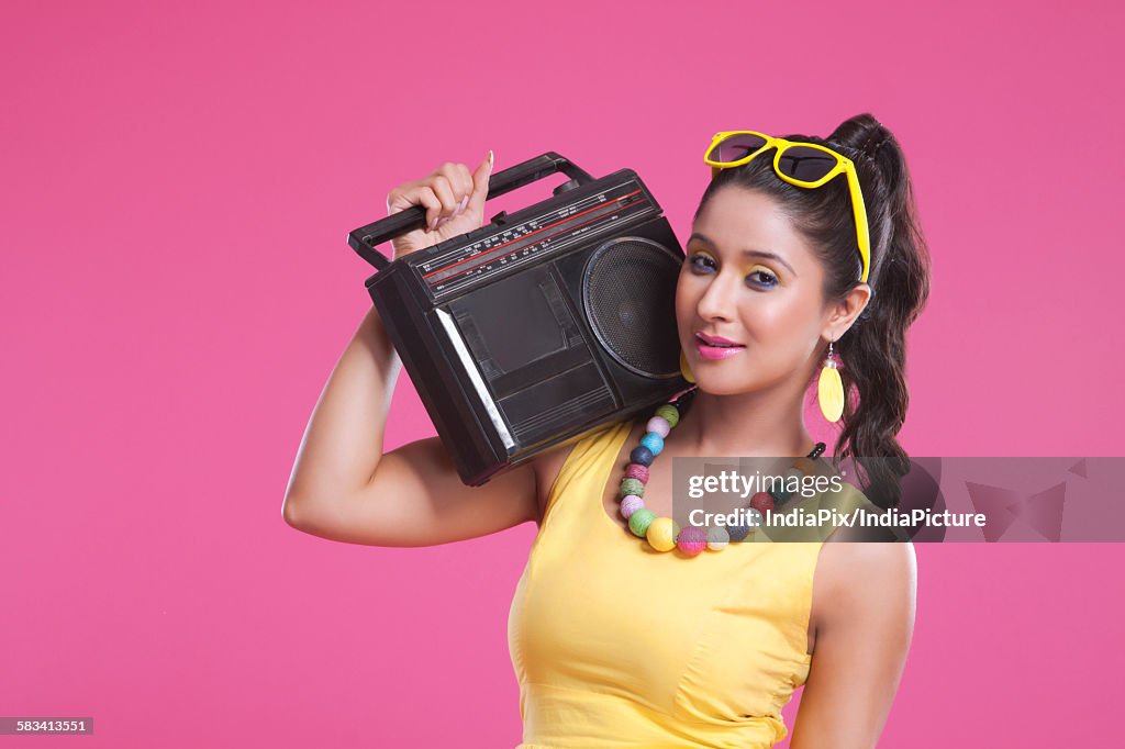 Portrait of woman with cassette player