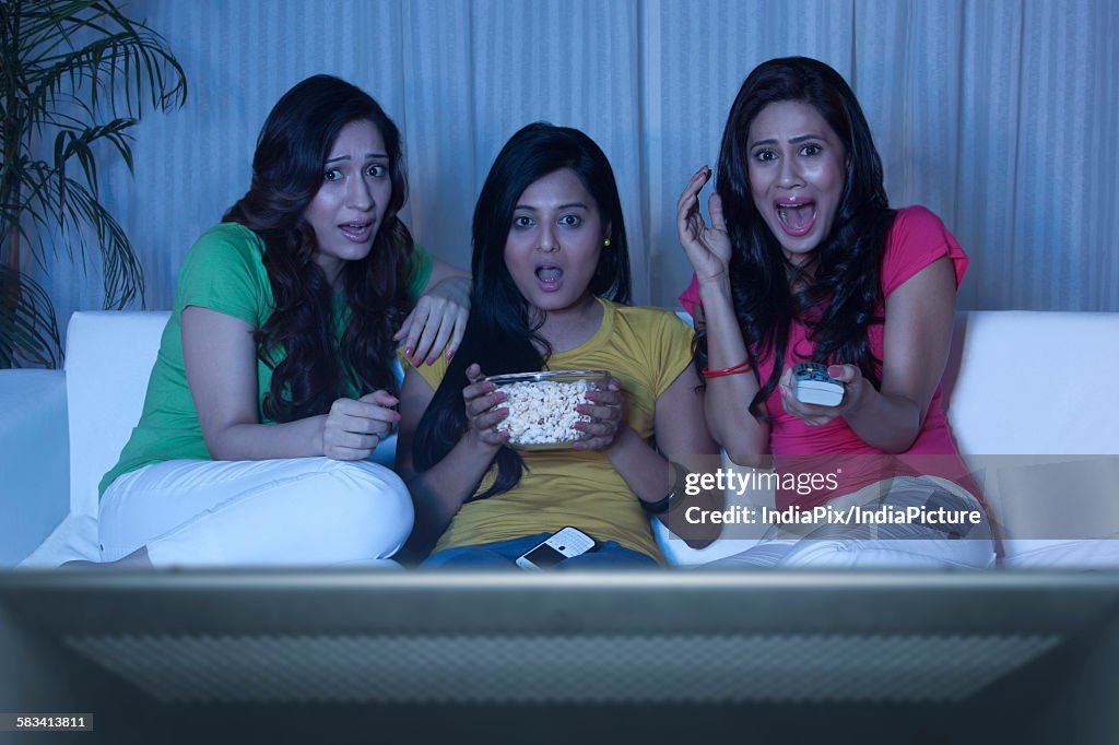 Young women watching a horror movie