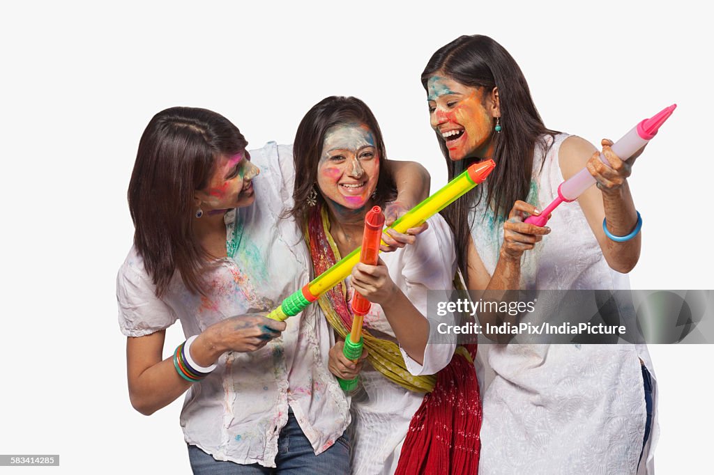 Three women playing holi