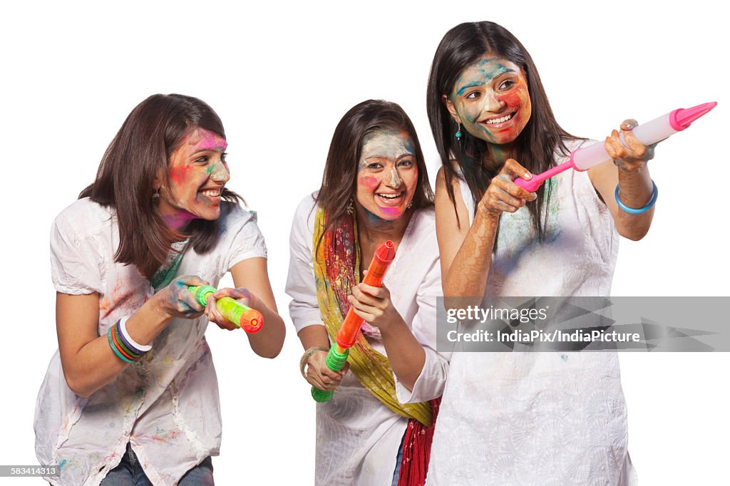 Three women playing holi