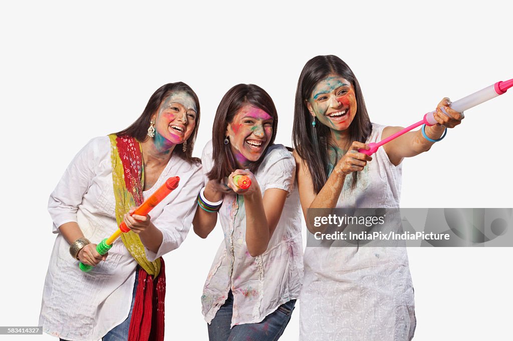 Three women playing holi