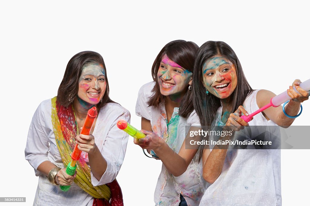 Three women playing holi