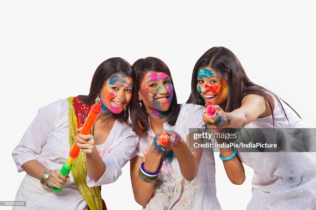 Portrait of three women playing holi