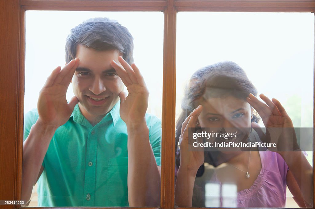 Portrait of couple looking inside new house