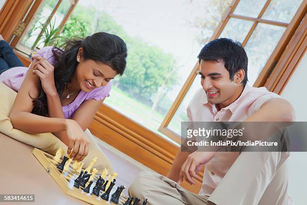 couple playing chess - newlywed game stock pictures, royalty-free photos & images