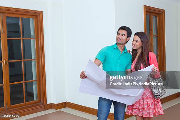 young man and young woman looking at lay out of house - glass map india stock pictures, royalty-free photos & images