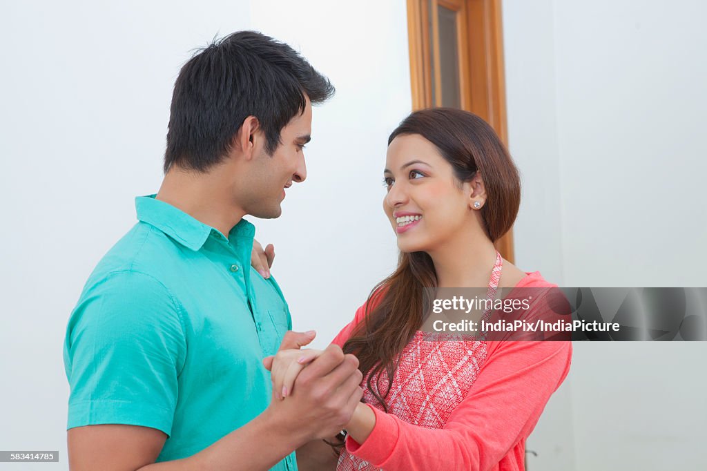 Young man and young woman dancing