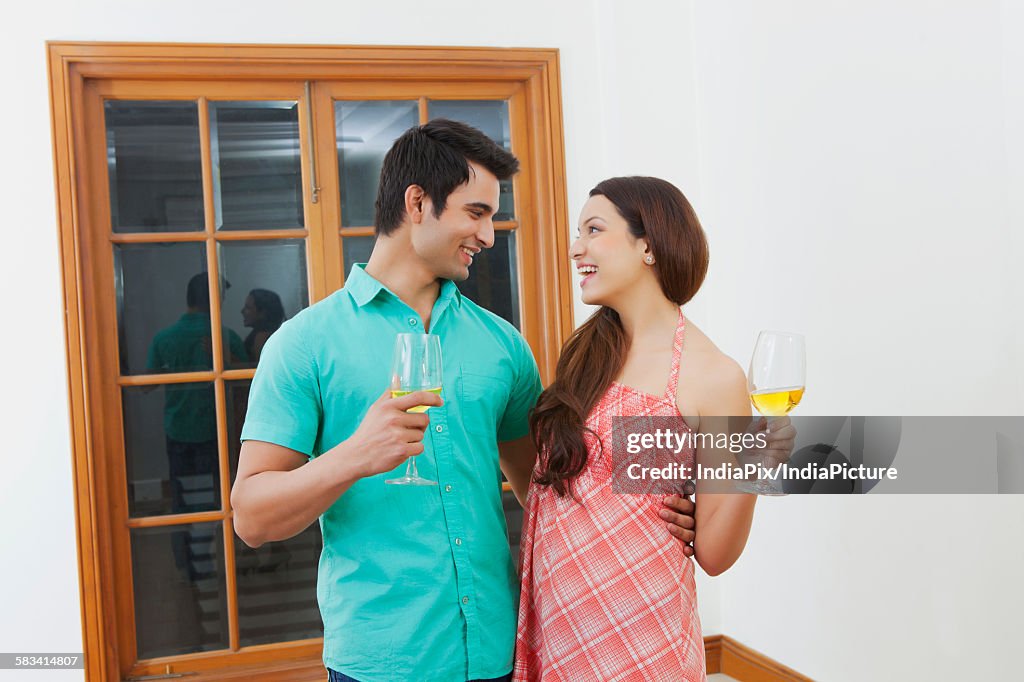 Young man and woman drinking wine