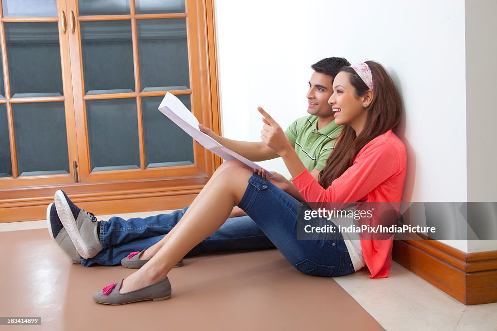 Young couple planning lay out of their house