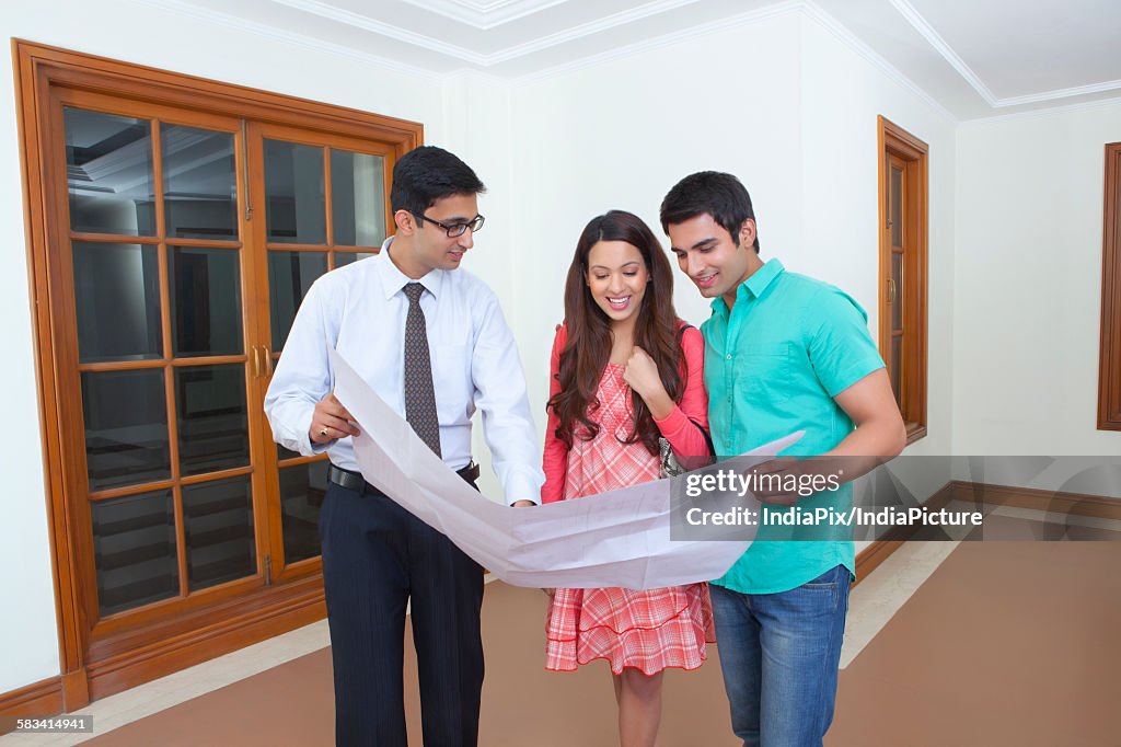 Agent showing property to young couple
