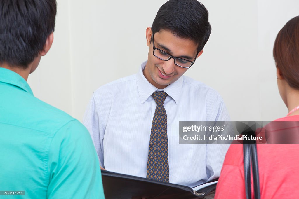 Agent selling property to young couple